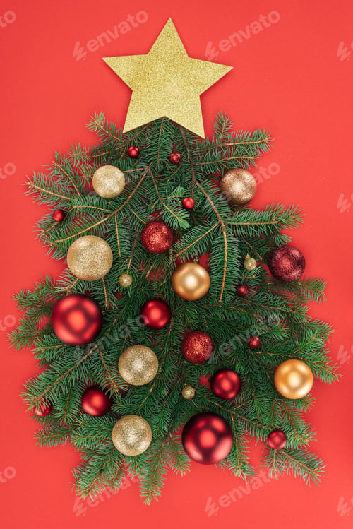 Preview: top view of pine tree branches, golden star and christmas balls arranged in christmas tree isolated