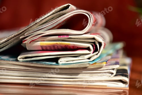 Preview: stack of newspapers on a wooden table
