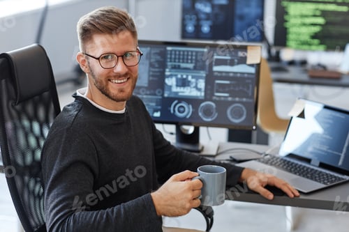 Preview: Smiling Computer Programmer at Workplace