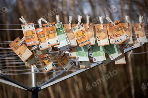 Preview: 100 and 50 euro banknotes drying. Washed Euro paper bills. Drying euro on a string.Money laundering