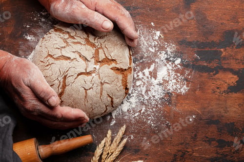 Preview: Baker holding fresh baked homemade bread