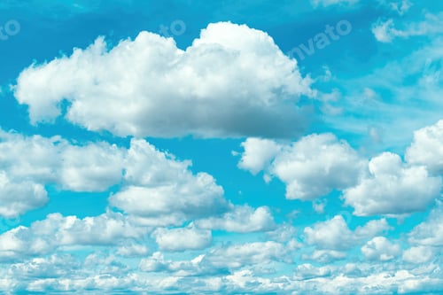 Preview: Fluffy white clouds on vibrant blue sky.