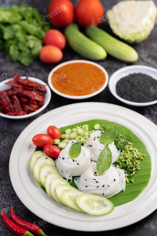 Preview: ืRice noodles in a banana leaf with beautifully laid vegetables and side dishes. Thai food.