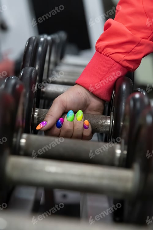Preview: Woman hand taking dumbbell