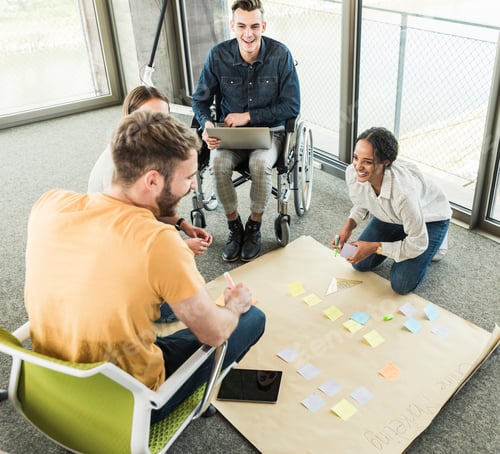 Preview: Happy young business people working together on a project in office