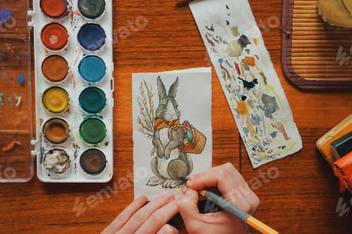 Preview: female artist painter painting a picture of a easter bunny