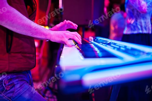 Preview: Close-up photo of musician's hands playing the synthesizer in the nightclub.