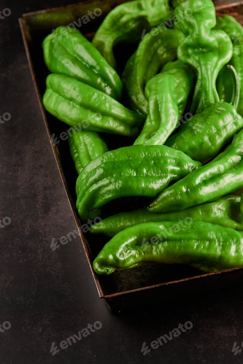 Preview: Vertical closeup shot of a box full of green chili peppers also known as Anaheim Pepper
