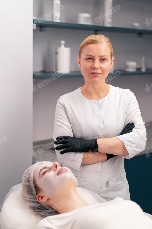 Preview: a cosmetologist is standing next to a patient who is lying on a couch during a procedure in salon