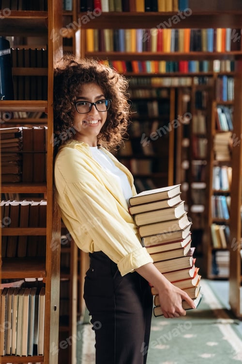 Preview: That's a lot of books in hands. Beautiful woman is in the library