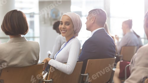 Preview: Portrait of happy young mixed race businesswoman smiling at camera during seminar in office building