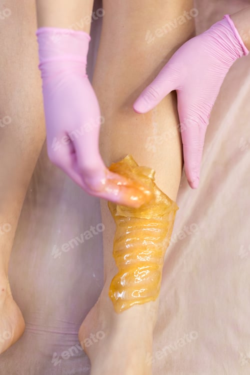 Preview: Sugar depilation of the feet in the beauty salon. Rid of hair on the legs. Sugaring.