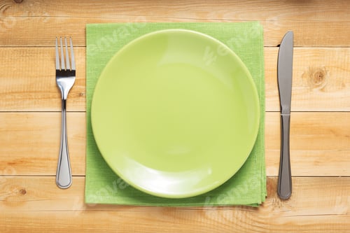 Preview: plate, knife and fork at wooden background