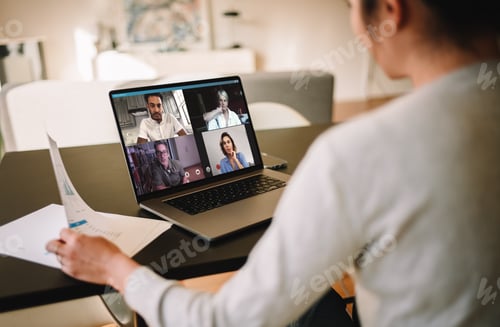 Preview: Businesswoman at home having a video conference with her team
