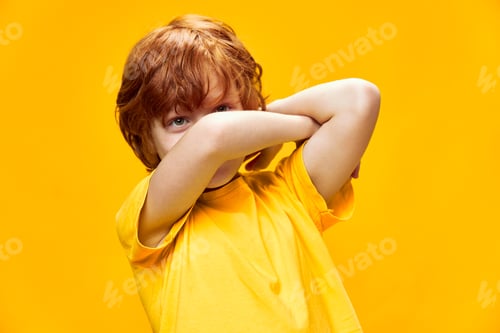 Preview: funny redhead boy holding crossed hands in front of face