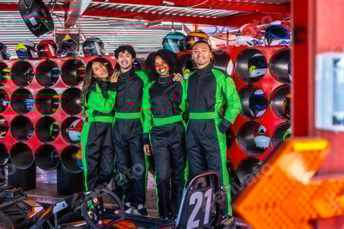 Preview: Friends Posing in Matching Racing Suits at Track