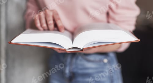Preview: Image focus conception. Girl searching for some information in the library full of books