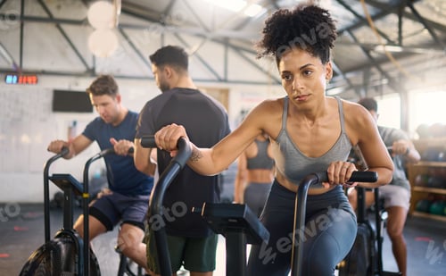 Preview: Fitness, class and bike workout of a black woman in a cycling, training and exercise studio. Bicycl