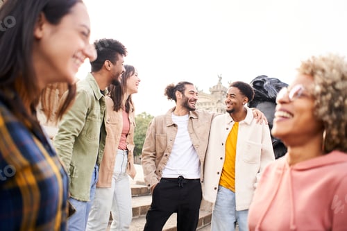 Preview: Youth culture. Group of young people laughing and talking outdoors in the city
