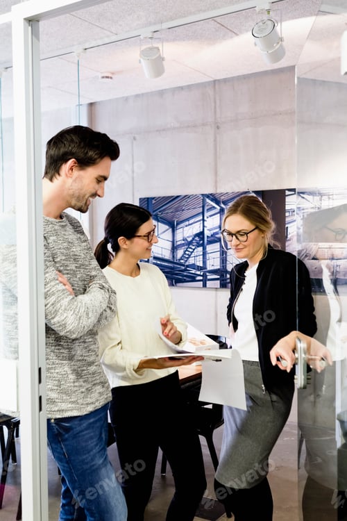 Preview: Colleagues in office doorway chatting