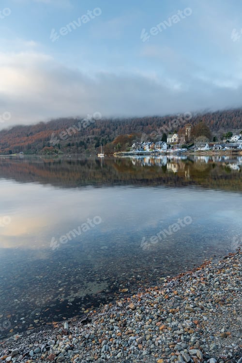 Preview: Kenmore town reflected in the Loch Tay Lake with autumn trees reflections, Perthshire, Highlands of