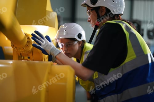 Preview: Robotics engineer working on maintenance of robotic arm in factory warehouse. Business technology.