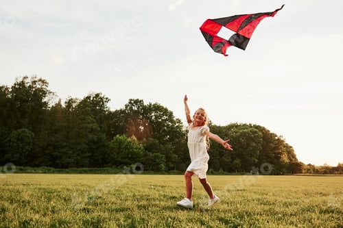 Preview: Come joing me. Happy girl in white clothes have fun with kite in the field. Beautiful nature