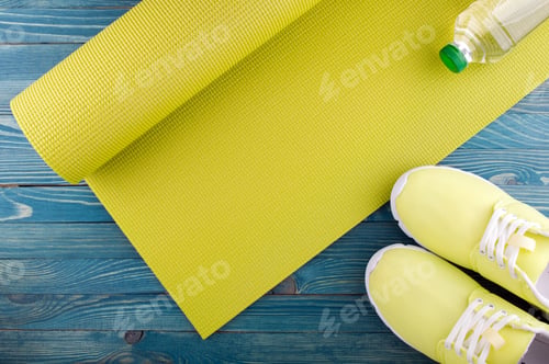 Preview: Yoga Mat, Water Bottle and Running Shoes on Wood