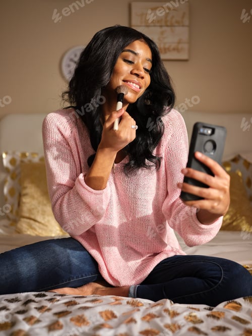 Preview: Woman Applying Makeup While Taking a Selfie