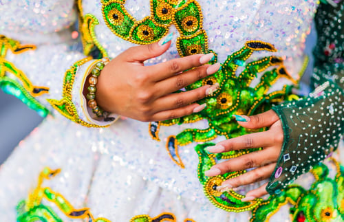Preview: Dancer showing traditional bolivian caporales dress and manicure during hispanic day parade