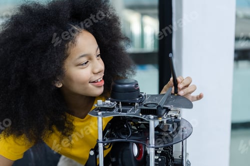 Preview: children girl with afro hairstyle education electronic on table at class room. learning innovation