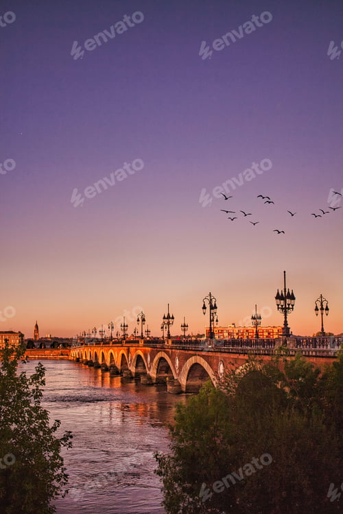 Preview: Bordeaux river bridge with St Michel cathedral during the sunset in France