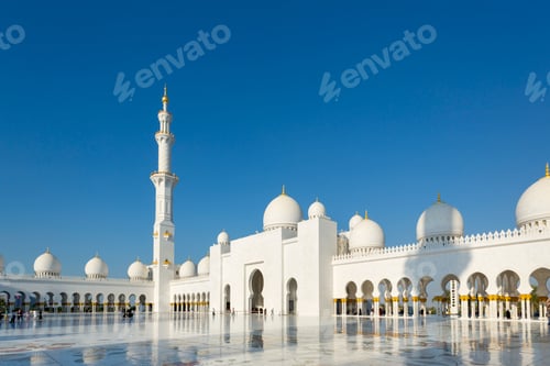 Preview: Sunset glow over the serene mosque with visitors walking through