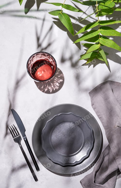 Preview: Festive table setting with dark grey plates and glass for a celebration with eucalyptus branches