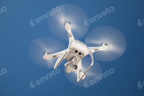 Preview: Drone Quadcopter From Below Against A Blue Sky
