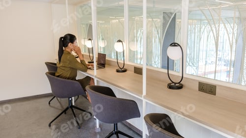 Preview: Asian women working in a hotel working space in a hotel for workation, commong working room in hotel