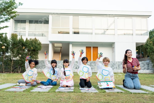 Preview: Portrait group of young student paint board outdoors in school garden.