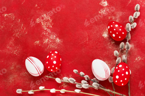 Preview: Red Easter background. Red and white Easter eggs and pussy willow branches on bright red background