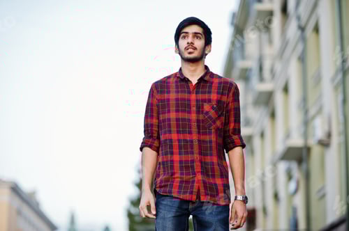 Preview: Young Adult in Plaid Shirt in Urban Setting