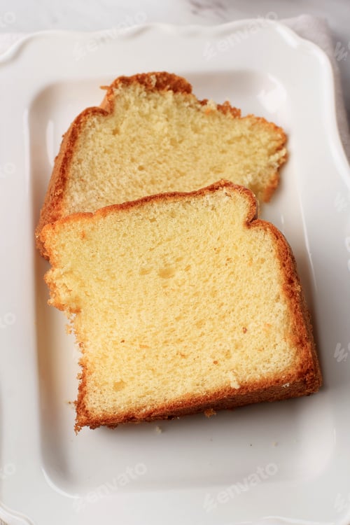 Preview: Slice of Fluffly Vanilla Chiffon Cake or Sponge Cake on Wooden Plate, Served with Tea and Honey