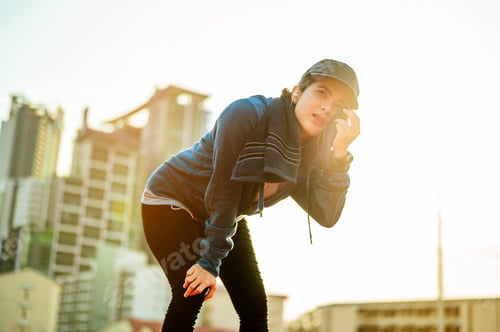 Preview: Sport asian woman resting and wipe the sweat by towel on her face after a hard workout.Running and j