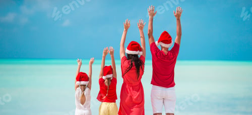Preview: Happy family with two kids in Santa Hat on summer vacation