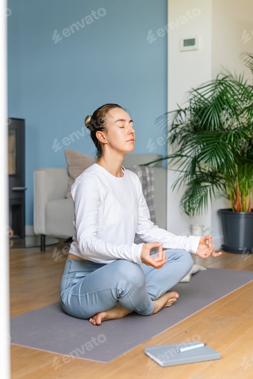 Preview: Young woman practicing meditation at home. Concept of mental health, women's wellness, mindfulness.