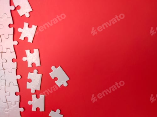 Preview: Unfinished white jigsaw puzzle pieces on red background