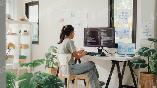 Preview: Asia girl IT development programmer typing on keyboard coding programming fixing data code.