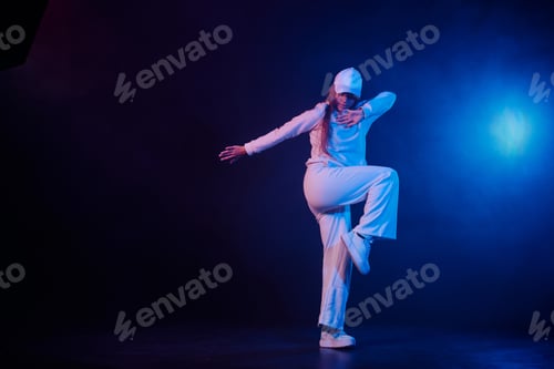 Preview: a girl in light clothes dances on a neon background in smoke, modern dance