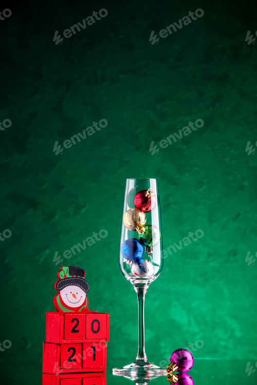 Preview: front view small xmas balls in wine glass wood blocks on green background