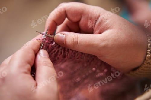 Preview: hands of a knitter close-up. A young girl knits knitting needles from pink yarn. hobby, handmade,