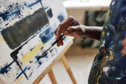 Preview: Close-up of hand of young creative African American painter
