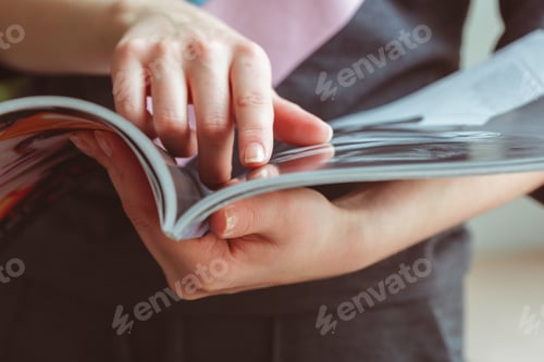Preview: Reading a magazine while sitting indoors during the day